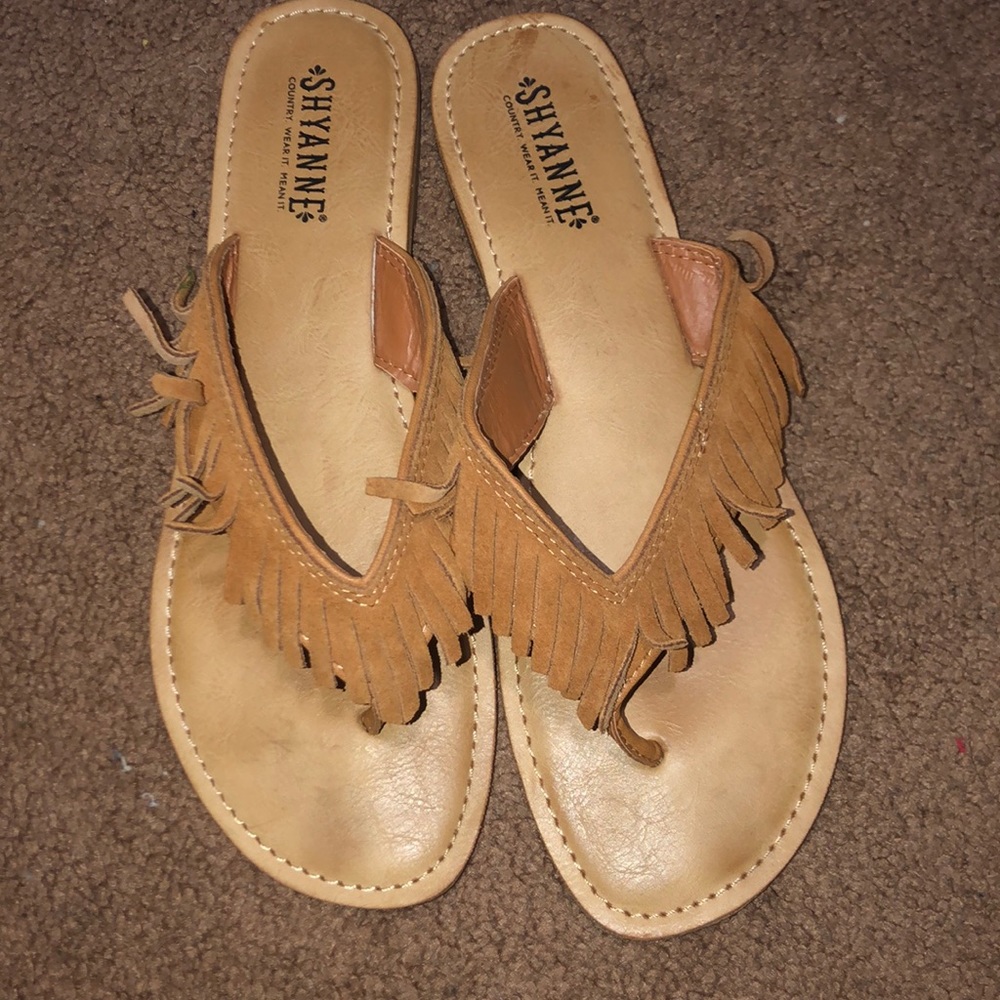Tan sandals with fridge straps.